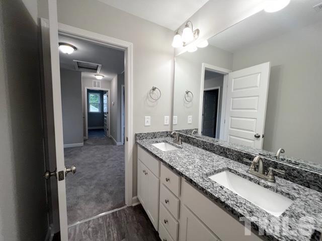 620 Ballance Road Fremont, NC 27830 - Photo 30 of 40 a bathroom with a granite countertop double vanity sink and a mirror