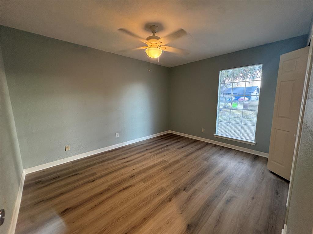 3309 Ridgeglen Circle Plano, TX 75074 - Photo 11 of 26 an empty room with wooden floor and windows