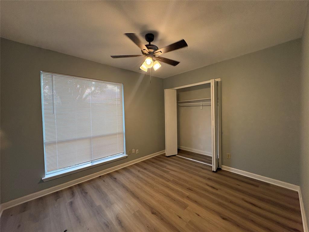 3309 Ridgeglen Circle Plano, TX 75074 - Photo 13 of 26 a view of an empty room with window and wooden floor