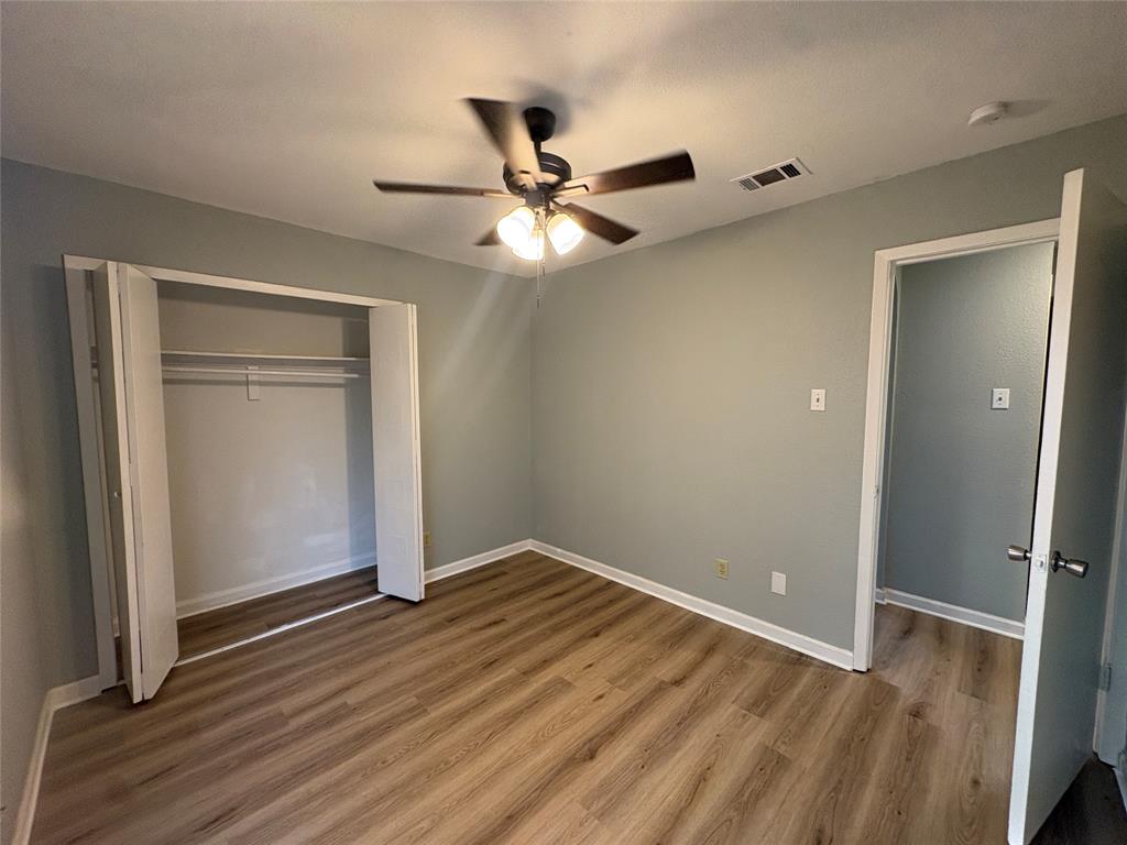 3309 Ridgeglen Circle Plano, TX 75074 - Photo 14 of 26 an empty room with wooden floor and a ceiling fan