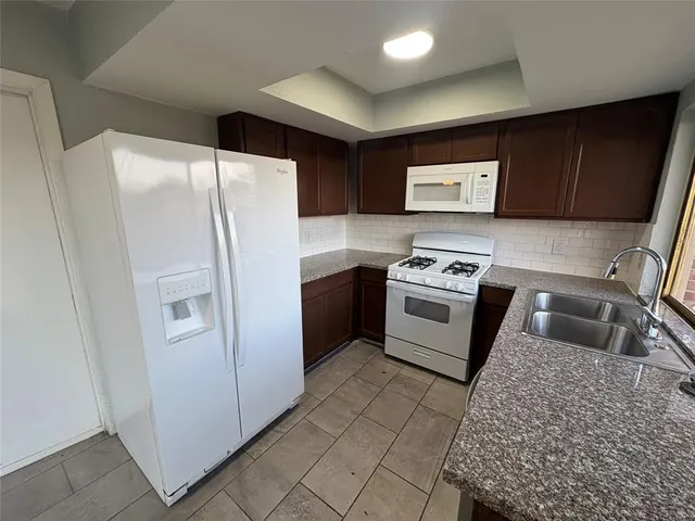 a white refrigerator freezer sitting inside of a kitchen