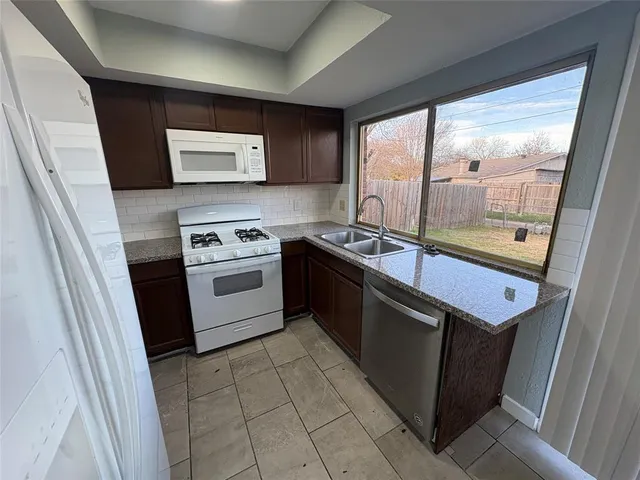 a kitchen with a stove a sink and a refrigerator