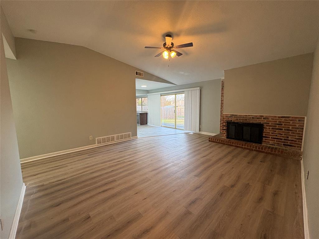3309 Ridgeglen Circle Plano, TX 75074 - Photo 3 of 26 a view of an empty room with wooden floor and a fireplace