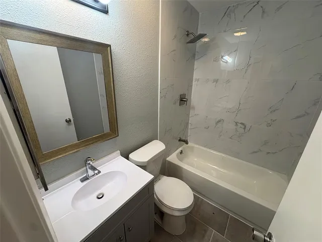 a bathroom with a sink toilet tub and shower