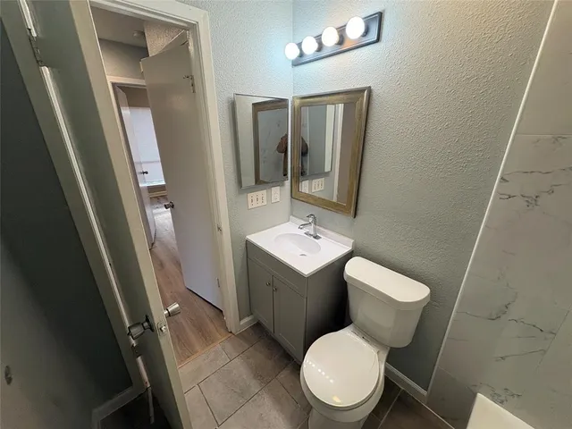 a white toilet sitting next to a bathroom sink