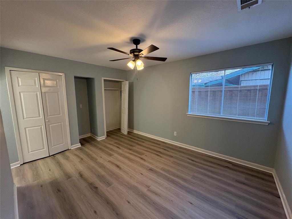 3309 Ridgeglen Circle Plano, TX 75074 - Photo 6 of 26 a view of an empty room with a window and wooden floor