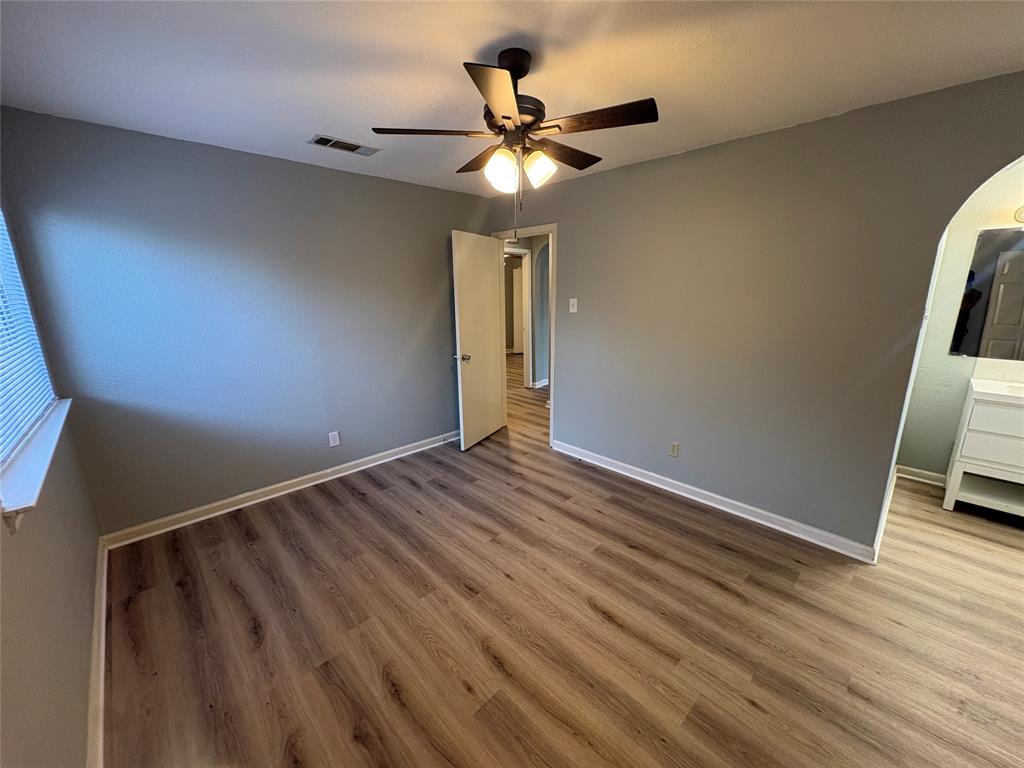 3309 Ridgeglen Circle Plano, TX 75074 - Photo 7 of 26 a view of an empty room with wooden floor and a ceiling fan