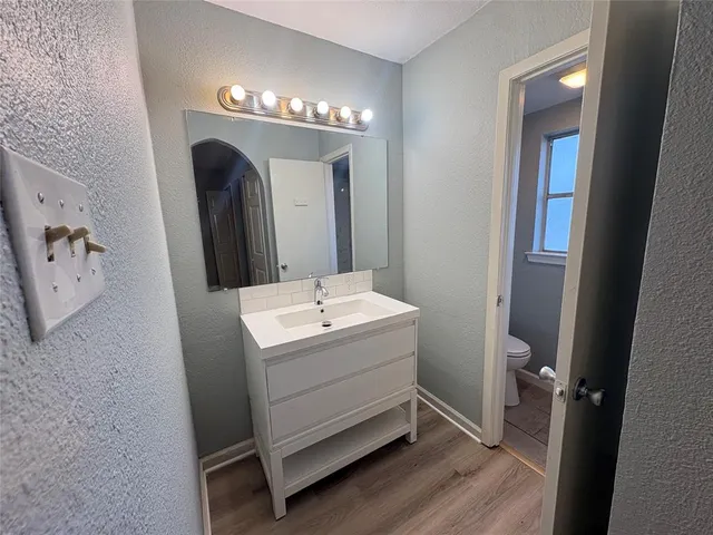 a bathroom with a double vanity sink and mirror