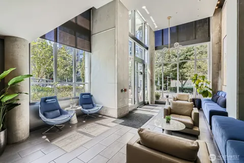 a living room with furniture and a floor to ceiling window