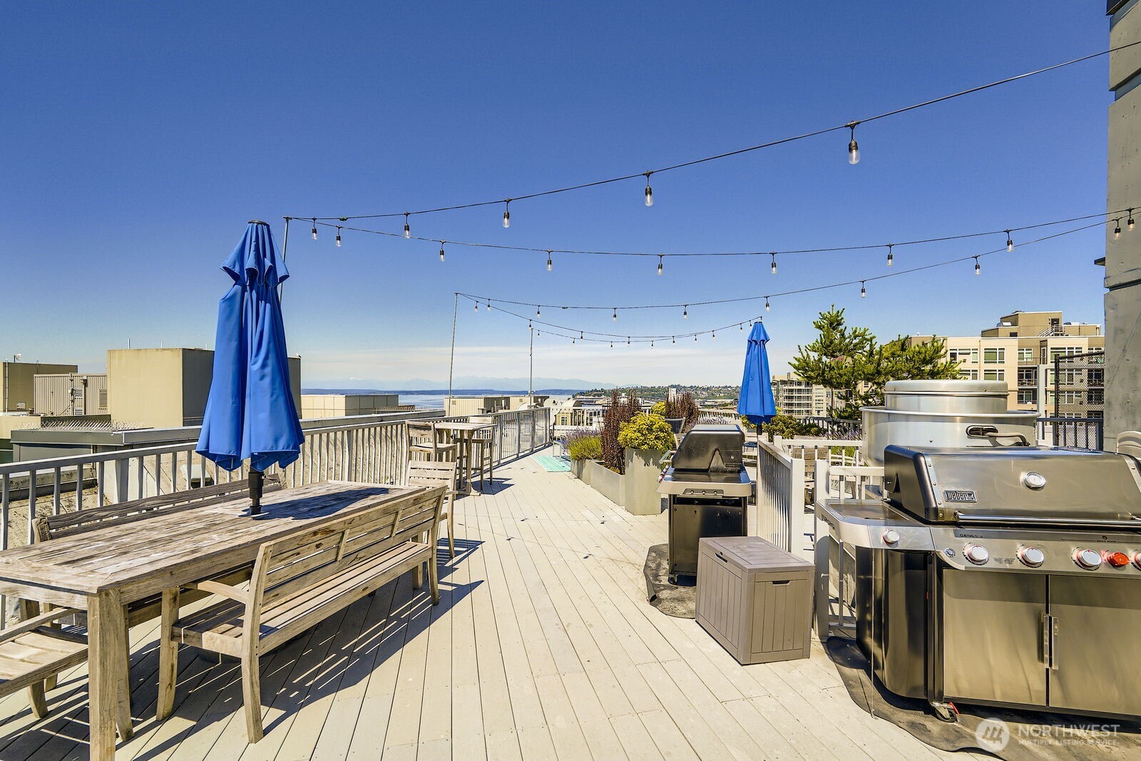 76 Cedar Street, Unit 806 Seattle, WA 98121 - Photo 20 of 21 a kitchen with stainless steel appliances kitchen island granite countertop a stove a sink and dishwasher