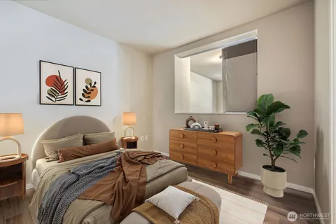 a bedroom with a bed and a potted plant