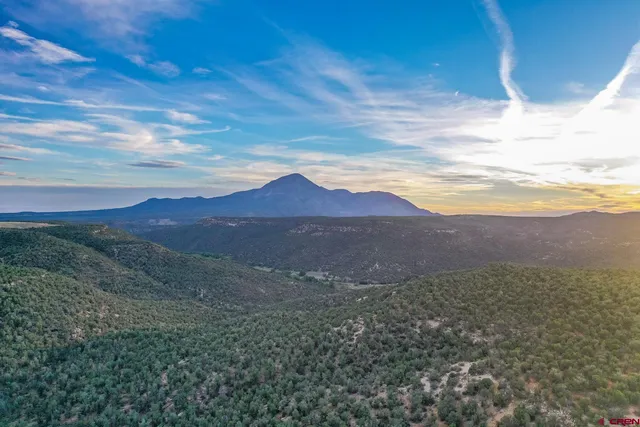 a view of mountains and valleys in the background