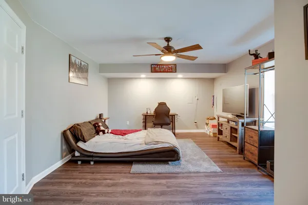 a room with pool table and wooden floor