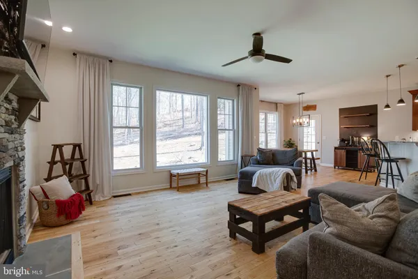 a living room with furniture a large window and a fireplace