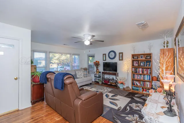a living room with fireplace furniture and a flat screen tv