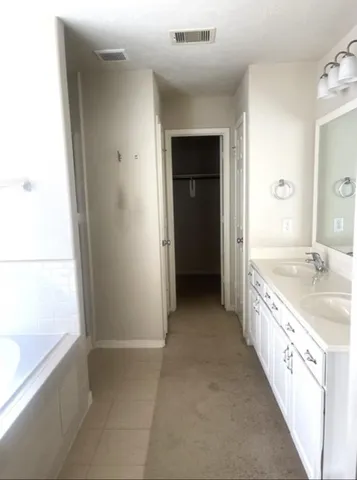 a bathroom with a granite countertop sink a bathtub and a shower