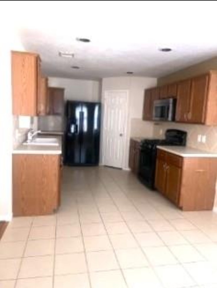 21942 Gosling Cedar Place Spring, TX 77388 - Photo 24 of 40 a kitchen with stainless steel appliances granite countertop a stove a sink dishwasher and a refrigerator