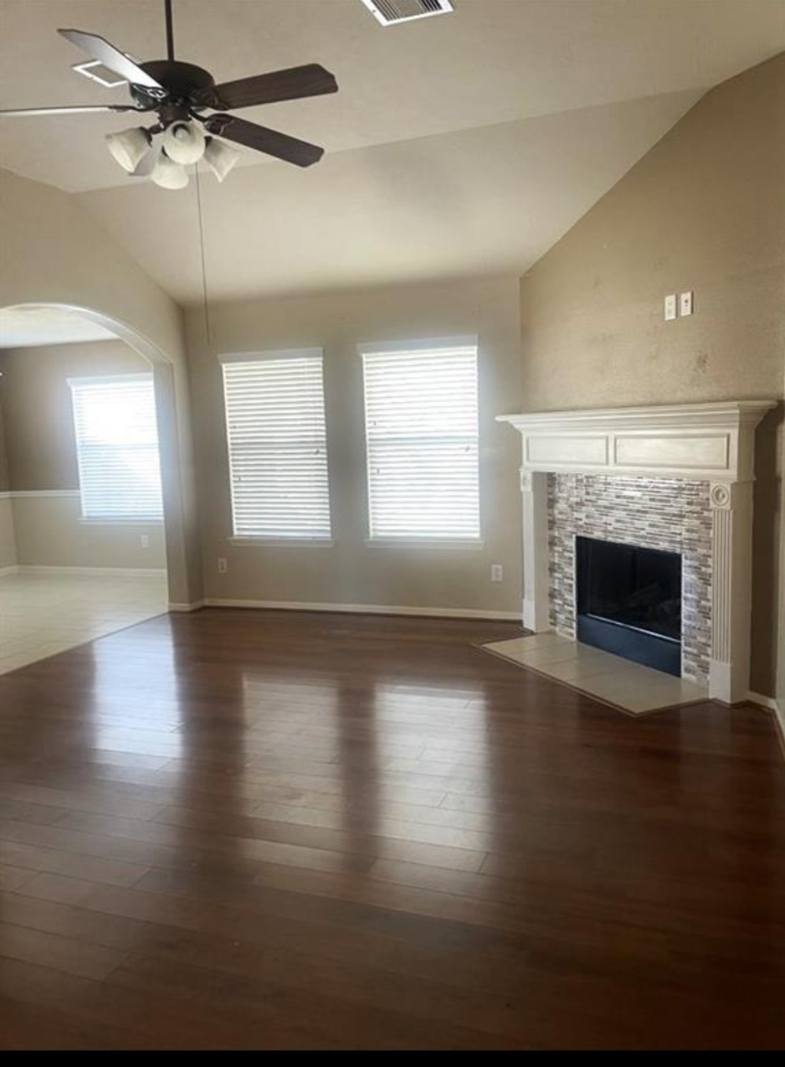 21942 Gosling Cedar Place Spring, TX 77388 - Photo 27 of 40 an empty room with wooden floor fireplace and windows