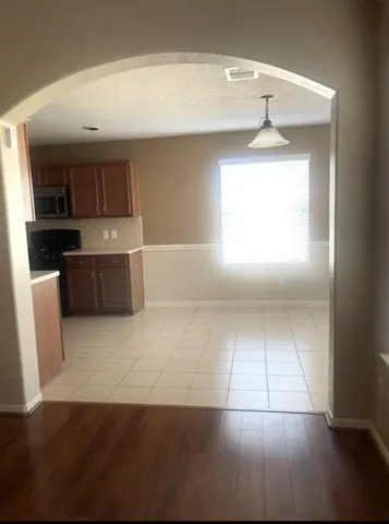 a view of a kitchen with a sink dishwasher and a refrigerator