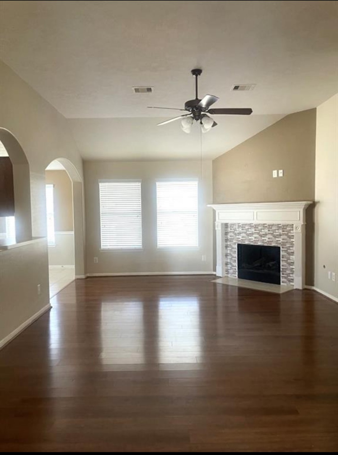 21942 Gosling Cedar Place Spring, TX 77388 - Photo 32 of 40 a view of an empty room with wooden floor fireplace and a window