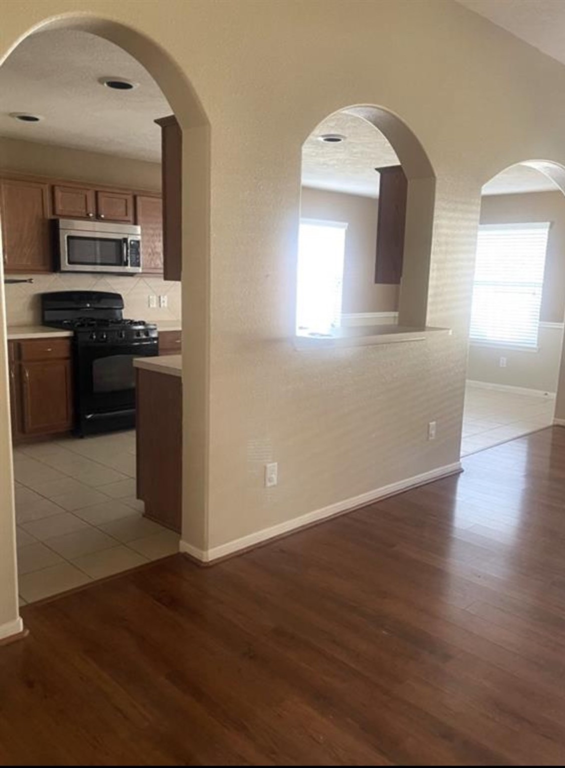 21942 Gosling Cedar Place Spring, TX 77388 - Photo 33 of 40 a view of a kitchen with wooden floor electronic appliances and window