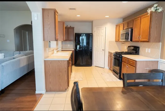 a room with a couch and a refrigerator