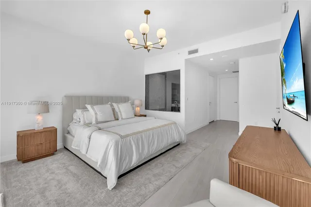 a bathroom with a tub double vanity sink and mirror
