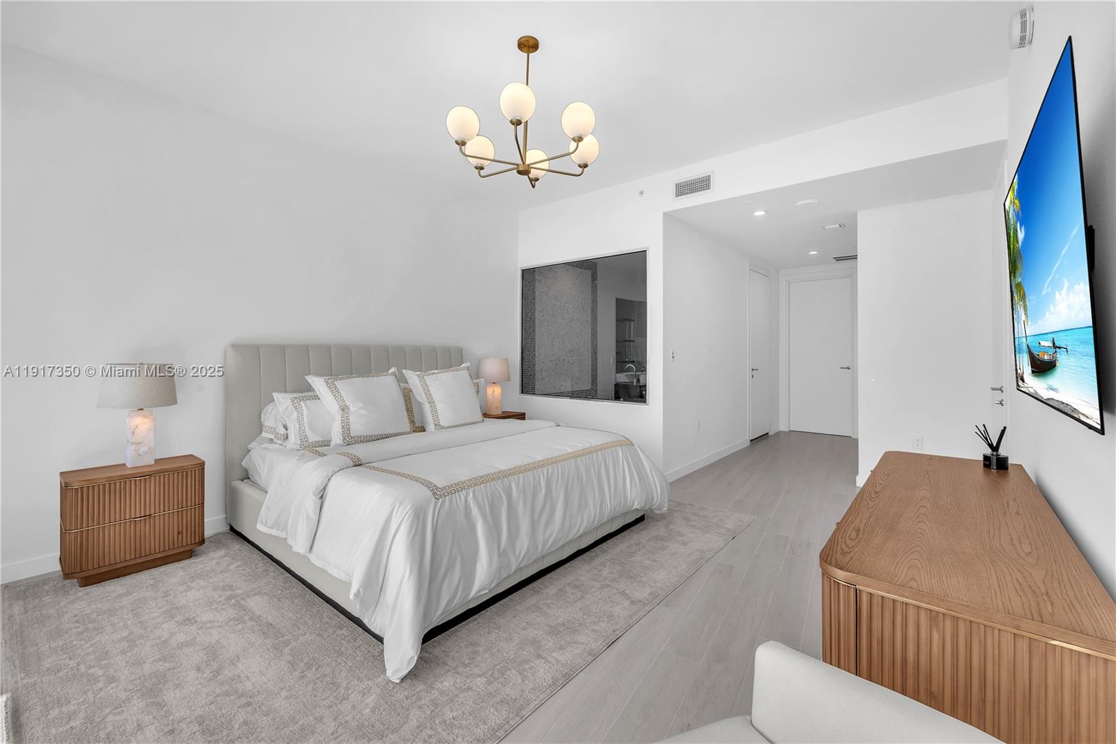 200 Biscayne Blvd Way, Unit 5103 Miami, FL 33131 - Photo 15 of 32 a spacious bedroom with a bed and a chandelier