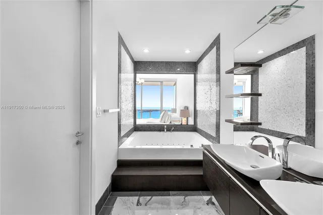 a bathroom with a double vanity sink toilet and shower