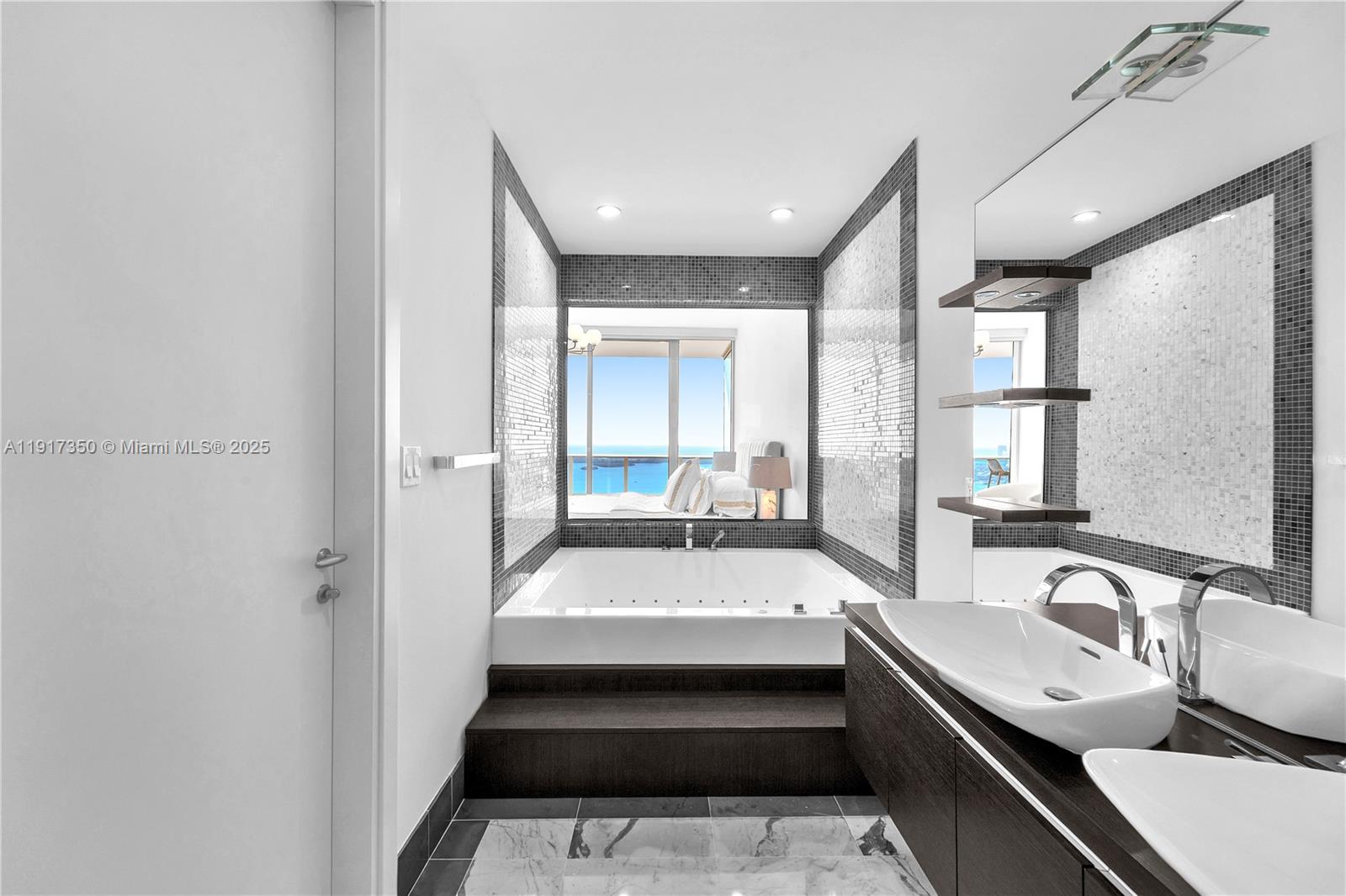 200 Biscayne Blvd Way, Unit 5103 Miami, FL 33131 - Photo 16 of 32 a bathroom with a tub double vanity sink and mirror