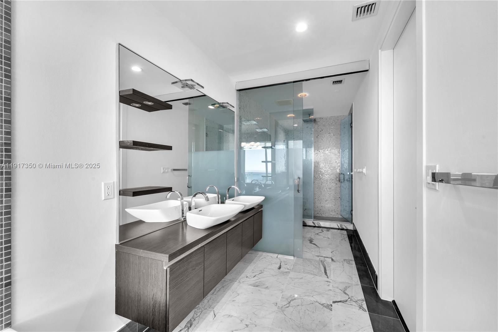 200 Biscayne Blvd Way, Unit 5103 Miami, FL 33131 - Photo 17 of 32 a bathroom with a double vanity sink toilet and shower