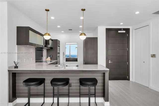 a view of kitchen with sink window and refrigerator