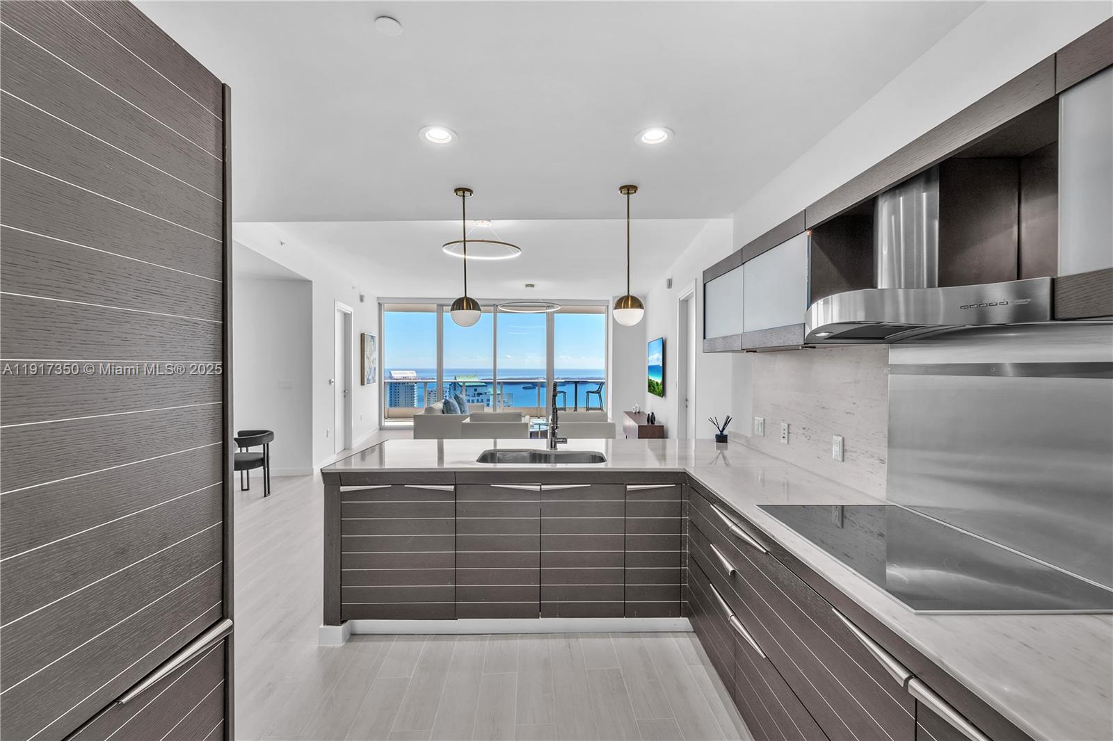 200 Biscayne Blvd Way, Unit 5103 Miami, FL 33131 - Photo 10 of 32 a kitchen with kitchen island cabinets a sink a stove and a refrigerator