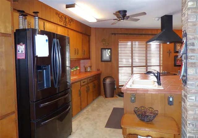a kitchen with stainless steel appliances granite countertop a refrigerator and a stove