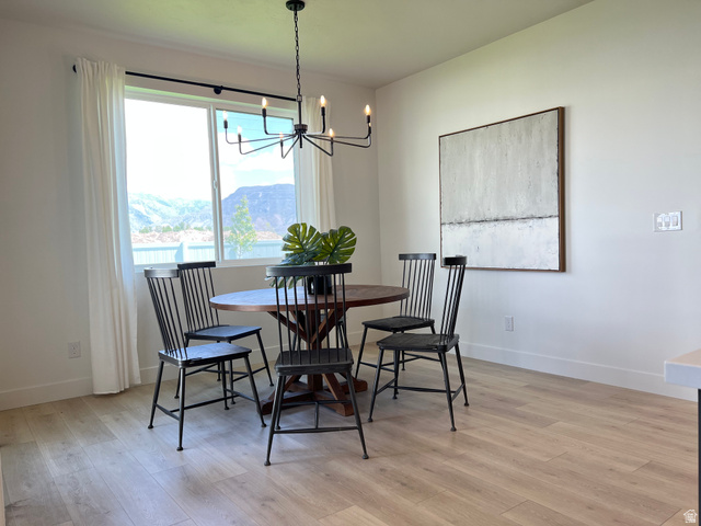 1951 2900 West Provo, UT 84601 - Photo 7 of 21 Dining area featuring a contemporary chandelier, large window with mountain scenery, and wood-finish flooring
