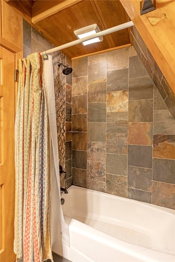 268 Cherry Drive Boone, NC 28607 - Photo 15 of 29 a bathroom with a shower and a bathtub
