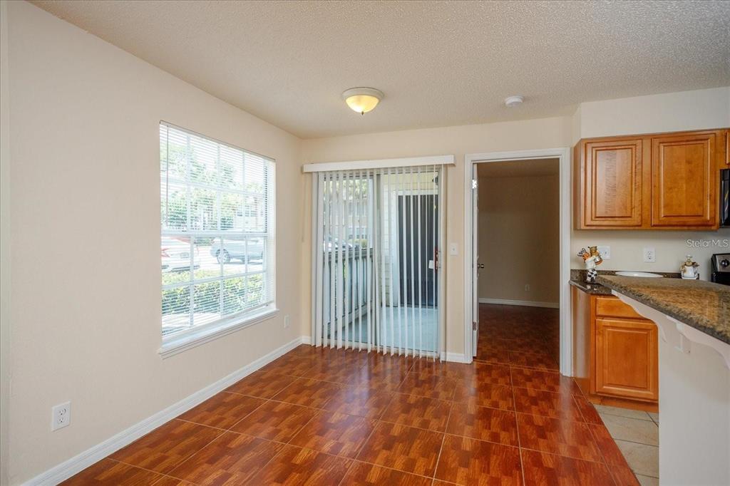 1083 South Hiawassee Road, Unit 617 Orlando, FL 32835 - Photo 5 of 12 a view of a kitchen with wooden floor and a sink