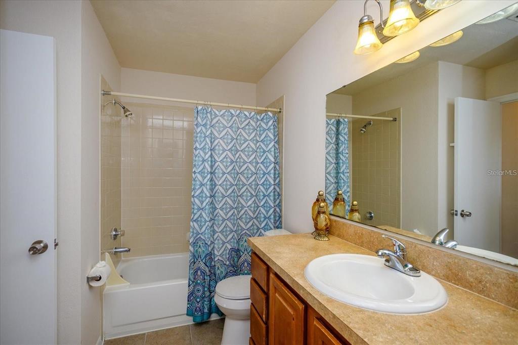 1083 South Hiawassee Road, Unit 617 Orlando, FL 32835 - Photo 7 of 12 a bathroom with a sink toilet and shower