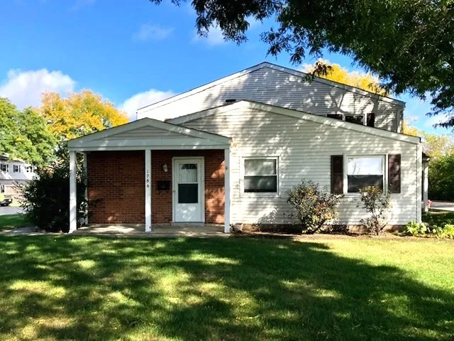 a front view of a house with yard and outdoor seating