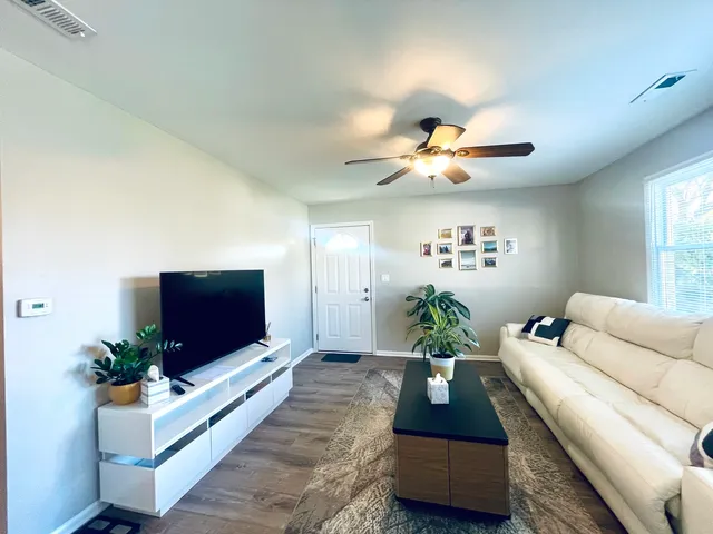a living room with furniture and a flat screen tv