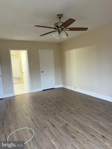 a view of an empty room and wooden floor