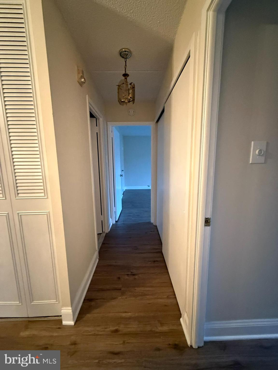 860 Lower Ferry Road, Unit 2K Ewing, NJ 08628 - Photo 11 of 14 a view of a hallway with wooden floor and staircase