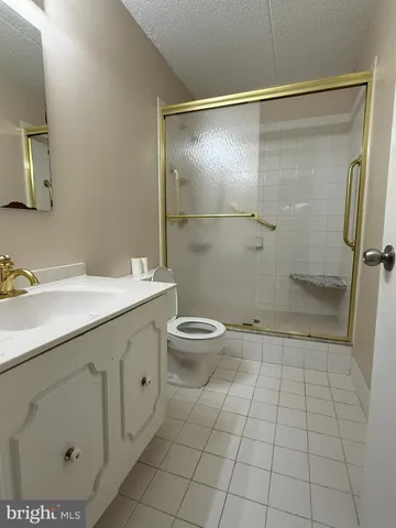 a bathroom with a double vanity sink toilet and shower