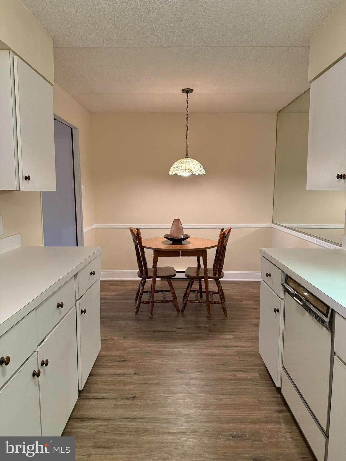 860 Lower Ferry Road, Unit 2K Ewing, NJ 08628 - Photo 9 of 14 a kitchen with stainless steel appliances a dining table chairs and white cabinets