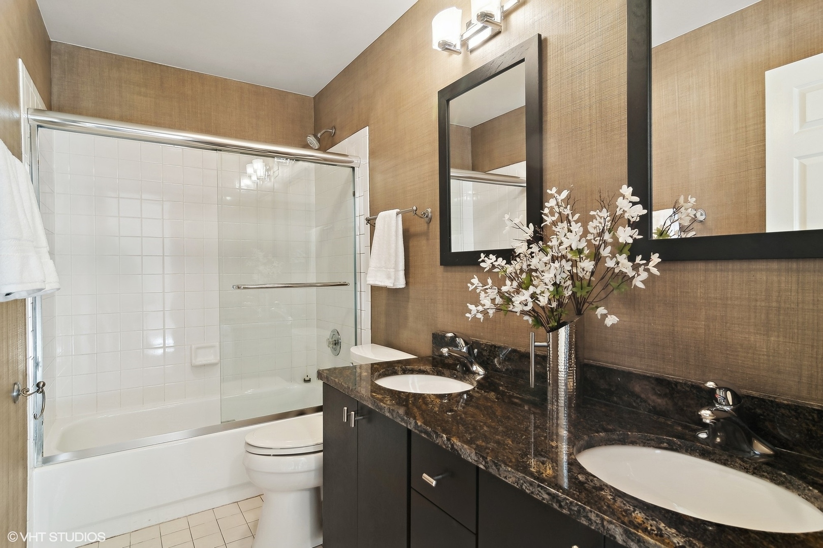 642 Raintree Road Buffalo Grove, IL 60089 - Photo 19 of 28 a bathroom with a granite countertop sink toilet a mirror a vanity and shower