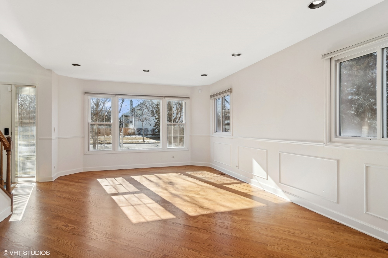 642 Raintree Road Buffalo Grove, IL 60089 - Photo 4 of 28 a view of an empty room with a window and wooden floor