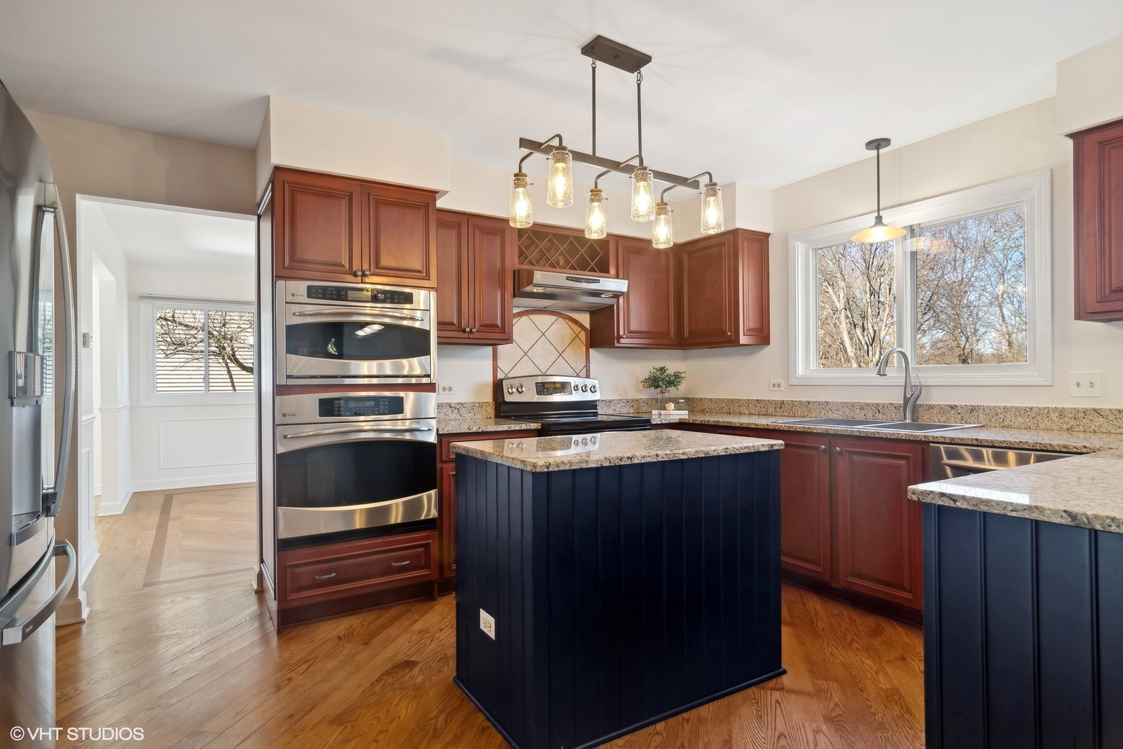 642 Raintree Road Buffalo Grove, IL 60089 - Photo 5 of 28 a kitchen with stainless steel appliances granite countertop a stove a sink and a refrigerator