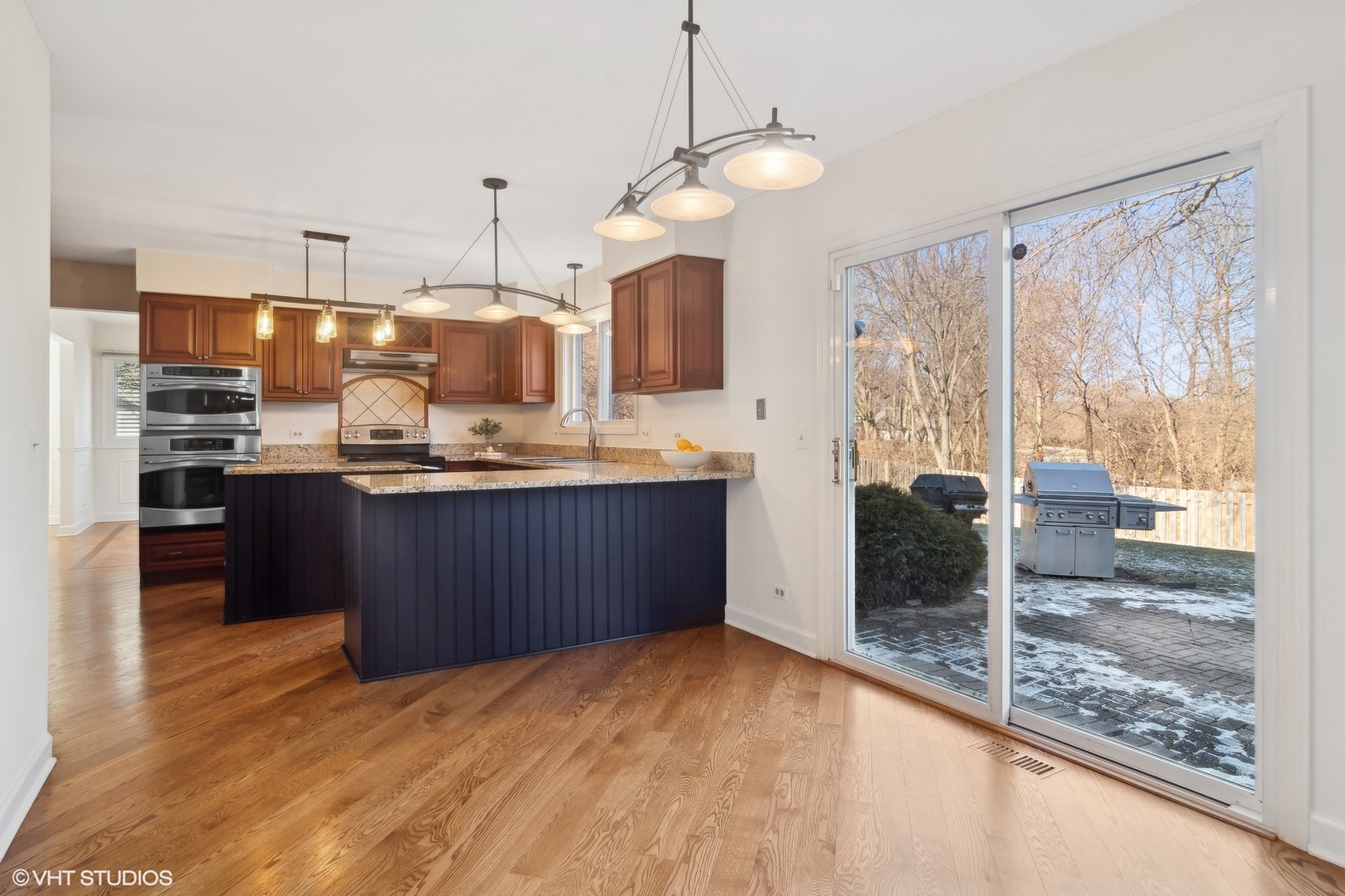 642 Raintree Road Buffalo Grove, IL 60089 - Photo 8 of 28 a kitchen with stainless steel appliances granite countertop a sink and cabinets