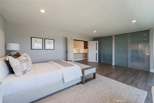 a spacious bedroom with a bed and a chandelier