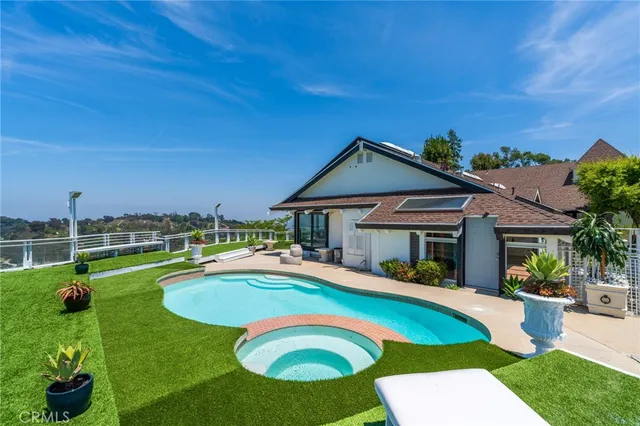 a swimming pool with outdoor seating and yard